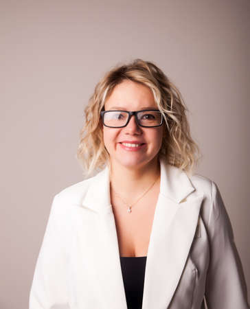 Portrait of a 30-year-old girl with glasses and a white jacket