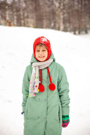 Portrait of nine-year-old girl in winter coat on walk in winter.の写真素材