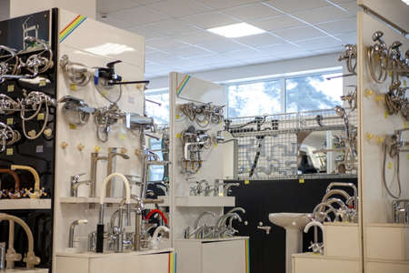 Water taps of different types and shapes on the counter in the store. Retail trade in sanitary ware. Foreground. Selective focusの写真素材