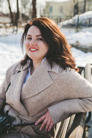 Woman of plus size, American or European appearance walks in city enjoying life. young lady with excess weightの写真素材