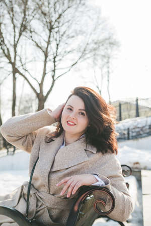 Woman of plus size, American or European appearance walks in city enjoying life. young lady with excess weightの写真素材