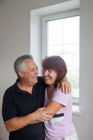 Elderly people are happy in new country house under constructionの写真素材