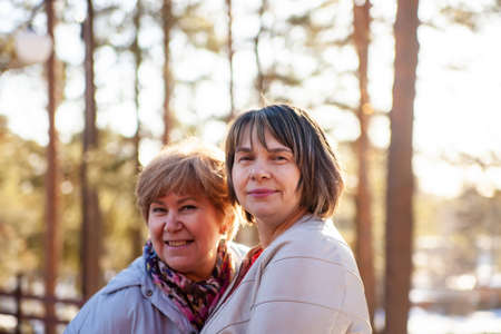 Beautiful well-groomed middle-aged women in spring parkの写真素材