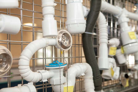 Shower siphon plastic parts in window of plumbing storeの写真素材