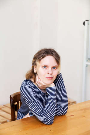 Portrait of teenage girl in blue striped sweatshirt in bright interior.の写真素材