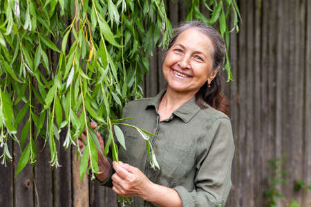 Portrait of beautiful middle-aged european woman against background of nature in summer.の写真素材