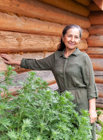 Portrait of beautiful middle-aged european woman against background of nature in summer.の写真素材