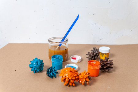 Concept of DIY and kid's creativity. Step by step instruction: painting pine cone.の写真素材