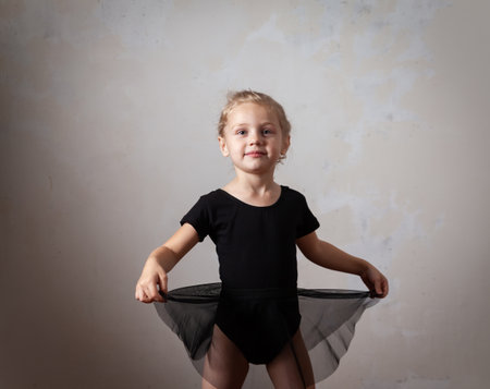 Girl dancing in ballet Studio. beautiful little blond girl standing in choreographic pose.の写真素材