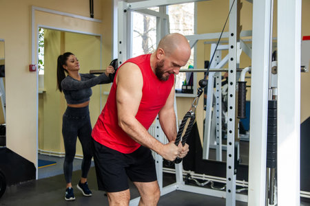 Fitness instructor with girl on training in fitness center