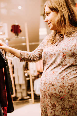 pregnant woman doing shopping early in the morningの写真素材