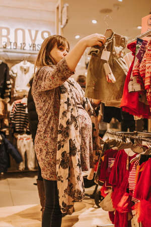 pregnant woman doing shopping early in the morningの写真素材