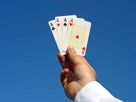 hand holding aces in the sky
