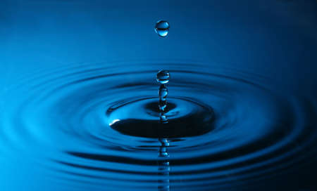 close up of a drop of water in blue colors