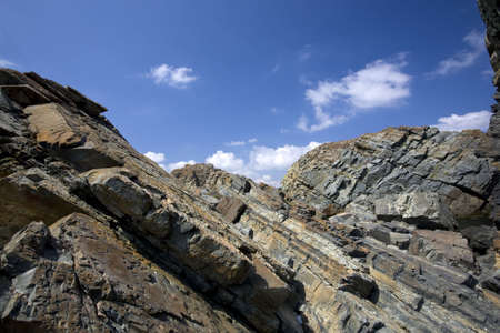Rocky cliffs against blue skyの写真素材