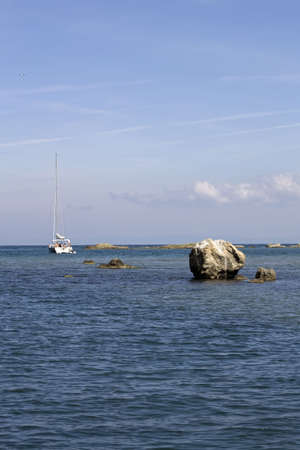 Black Sea coast and a beautiful yacht with white sailsの写真素材