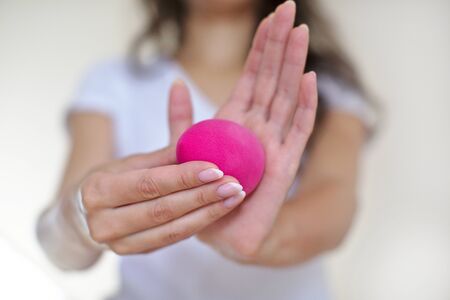 The girl in the bathroom, in a white t-shirt makes makeup with pink beauty blender, woman holds a brush cosmetics, sponge Konjac, makeup tool, beauty blog, morning routineの写真素材