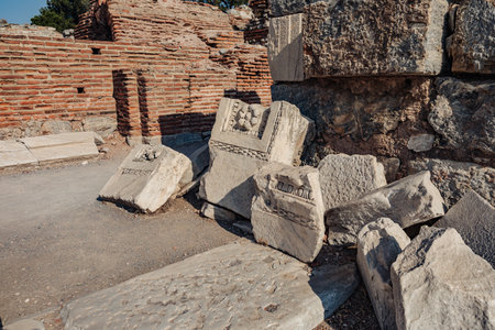 Close-up of ancient stone columns in a historic Turkish city. Intricate carvings and weathered...