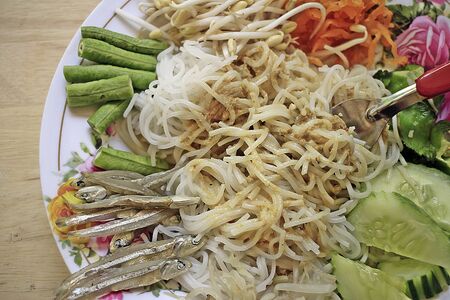 Noodles with curry of yard long bean on a white plateの写真素材