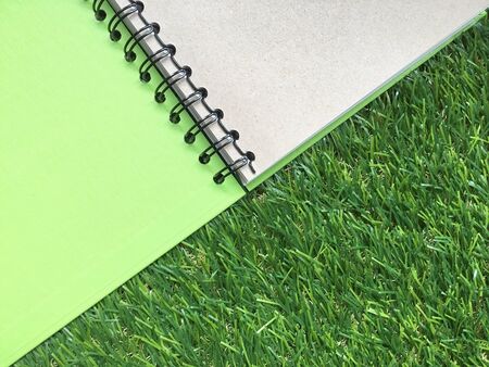 Note book on grass backgroundの素材