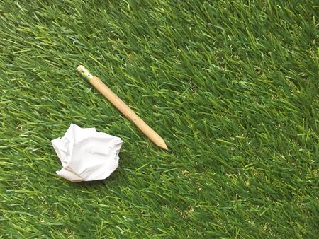 Note book on grass backgroundの素材