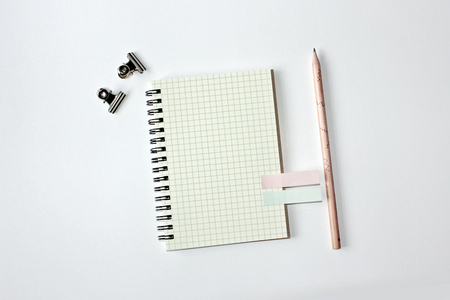 Blank white graph line notebook with pencil,  and paperclipsの写真素材