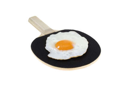 fried egg on black bat isolated on white background