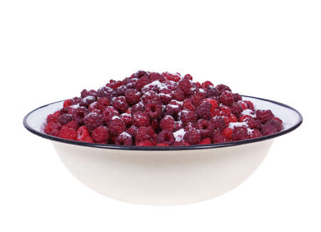 raspberries in big tin bowl isolated on white backgroundの写真素材