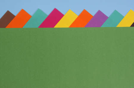 arranged colourful paper with stripes as backgroundの写真素材