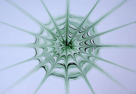 spiderweb made from green paint as backgroundの写真素材