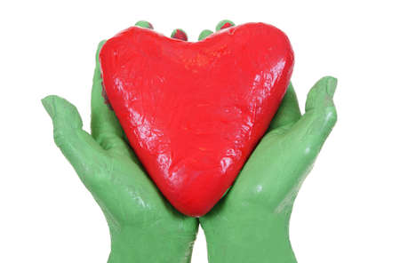 red heart keping in green hands isolated on white backgroundの写真素材