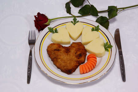 pork chop in form of heart on a plateの写真素材