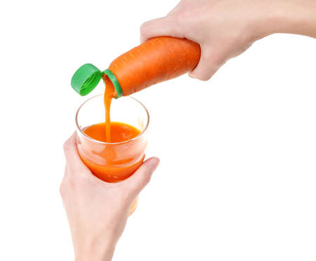 juicy carrot and glass full of juice isolated on white backgroundの写真素材
