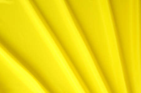 arranged yellow and silky cloth as backgroundの写真素材
