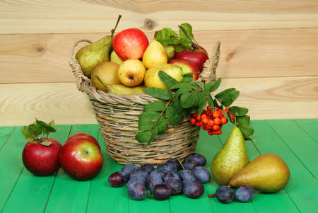  full basket of fruit on green tableの写真素材