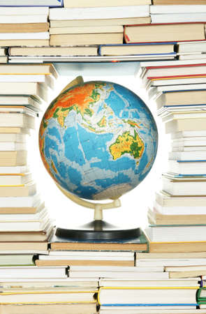 arranged books and globe on white backgroundの写真素材