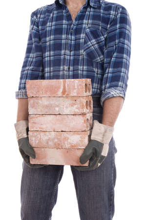 man in gloves keeps the  heap of bricks