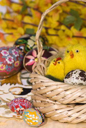 colourful easter eggs and wicker on flower backgroundの写真素材