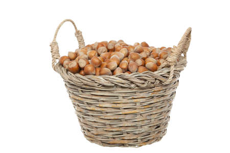 whole hazelnuts in wicker on white backgroundの写真素材