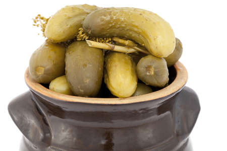 pickled cucumber in stoneware on white backgroundの写真素材