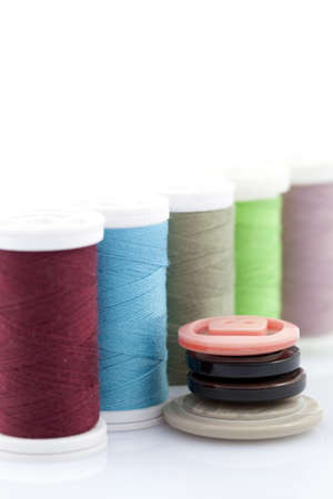 colourful cotton thread on spool and button 