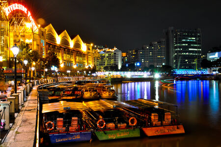 SINGAPORE - OCTOBER 19: Clarke Quay at Night with Boats on Singapore River on October 19, 2012....