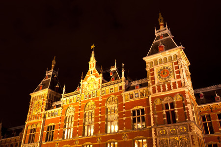 AMSTERDAM - JULY 27: Central Station by night, as seen on July 27, 2013 in Amsterdam, Netherlands. Central Station is the central railway station of Amsterdam and is used by 250,000 passengers a day.のeditorial素材