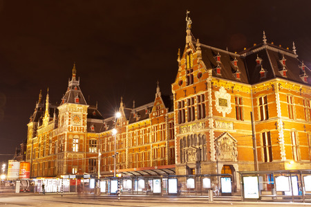 AMSTERDAM - JULY 27: Central Station by night, as seen on July 27, 2013 in Amsterdam, Netherlands. Central Station is the central railway station of Amsterdam and is used by 250,000 passengers a day.のeditorial素材