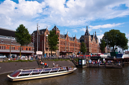 AMSTERDAM - AUGUST 16: Central Railway Station on August 16, 2013 in Amsterdam. Central Station is the central railway station of Amsterdam and is used by 250,000 passengers a day.のeditorial素材