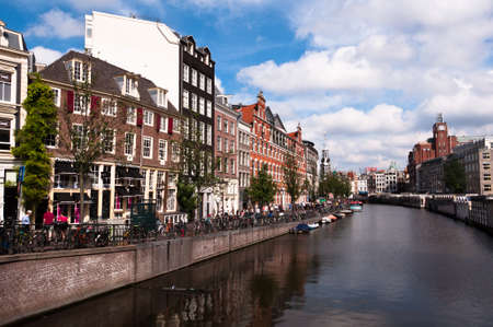 AMSTERDAM, NETHERLANDS - JULY 27, 2013: Common view of houses and canals of Amsterdam in summer of 2013.のeditorial素材