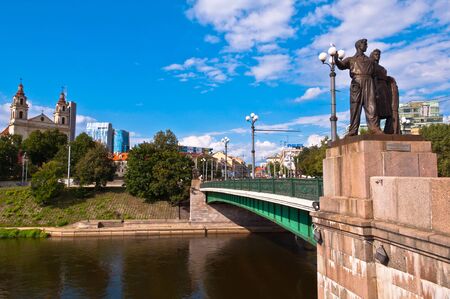 The Green Bridge over Neris river in Vilnius with city panoramaのeditorial素材