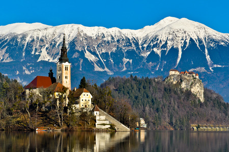 St. Martin Church on Island in Lake Bled with Beautiful Mountain Landscapeのeditorial素材