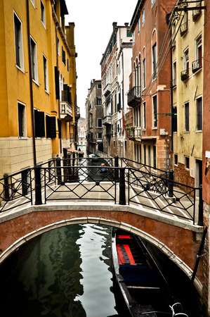 Beautiful View of Canal with Bridge and Houses in Venice, Italyの写真素材