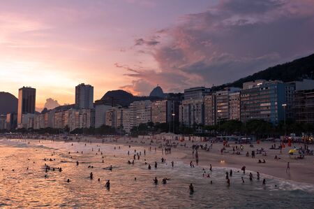 Copacabana Beach View with Hotel Buildings and Mountains by Warm Sunset in Rio de Janeiro, Brazilの写真素材